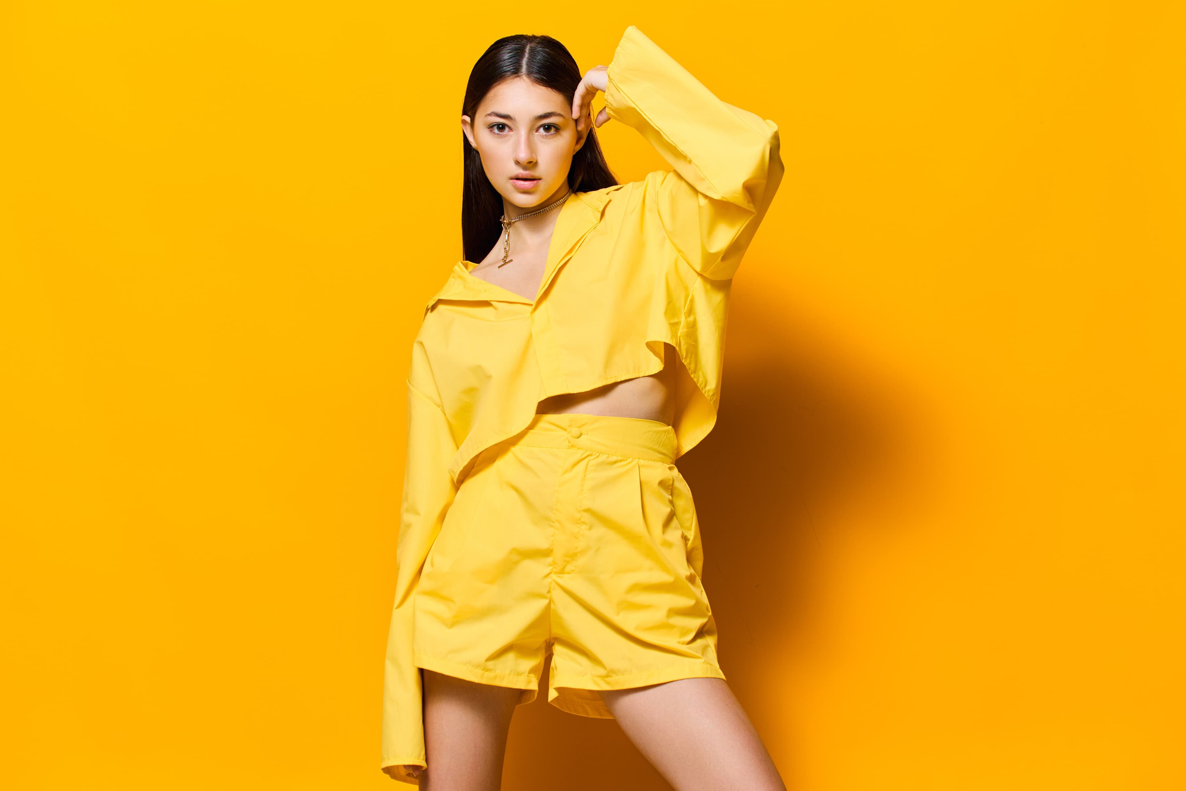 Woman in yellow against a bright yellow background